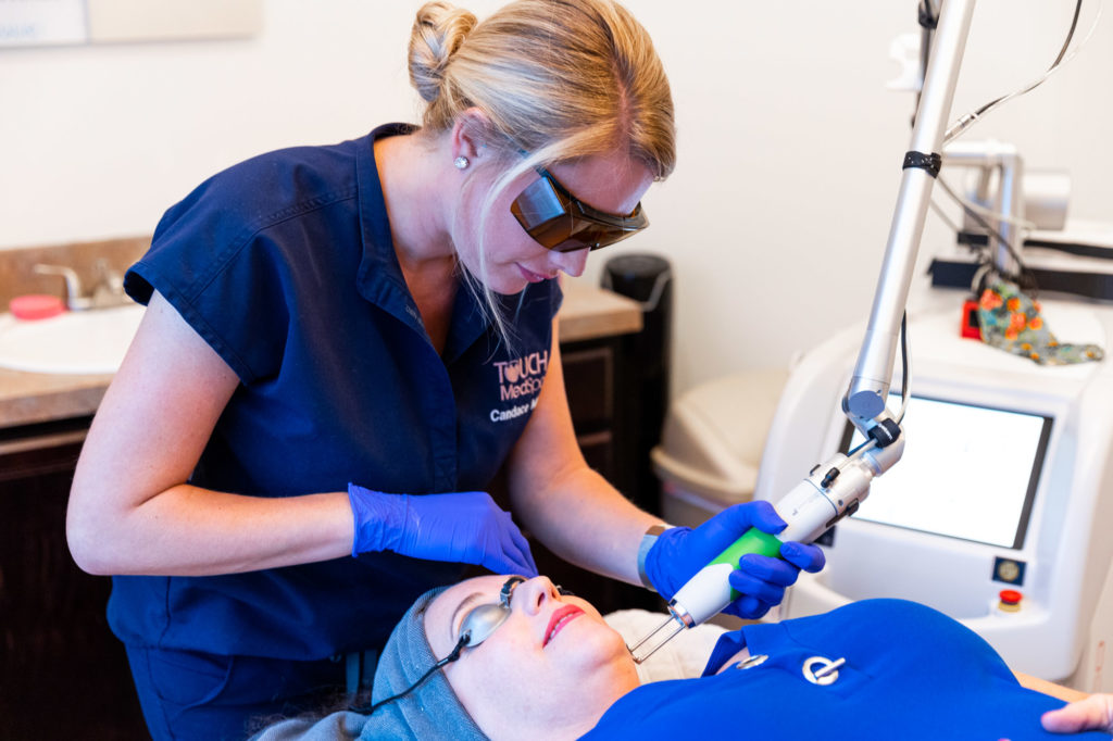 Touch Esthetician Using Laser on a Patient's Face