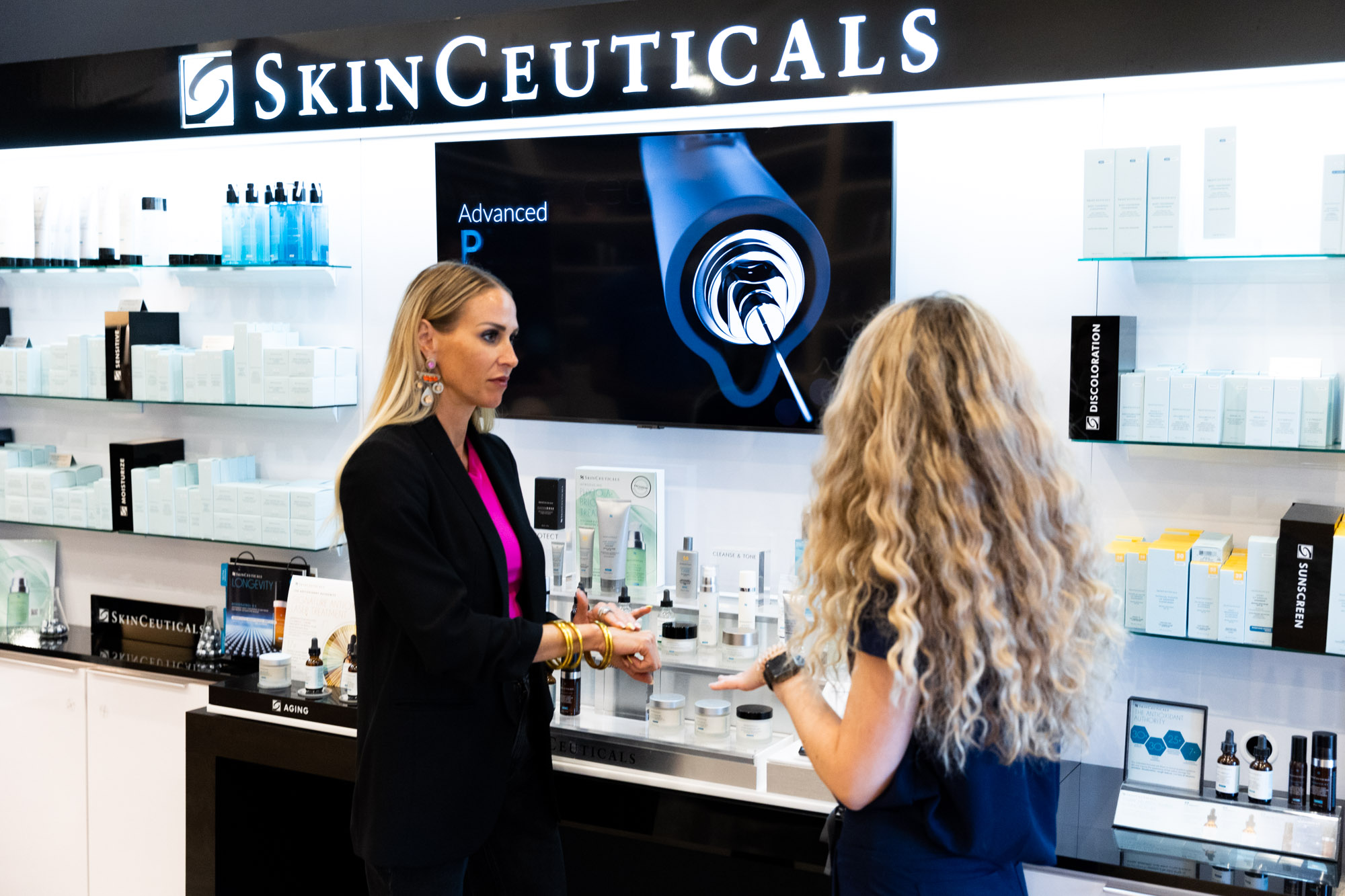 Touch MedSpa skincare professional talking to a patient about skincare products